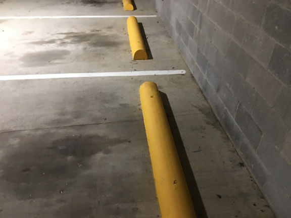 Cement wheel stops in parking garage in Tyler, TX